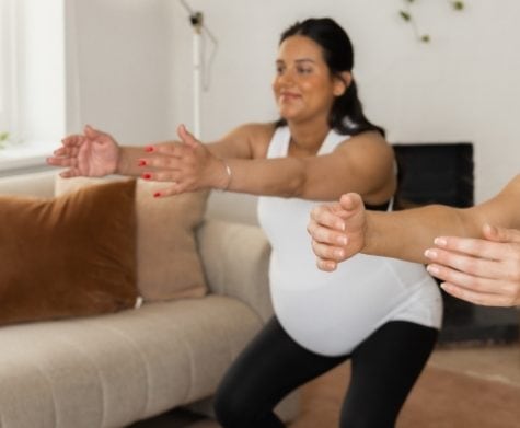 Pregnant mum and postnatal mum doing online pilates workout from home